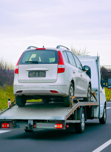 Long Distance Towing - A truck towing a vehicle on a scenic road